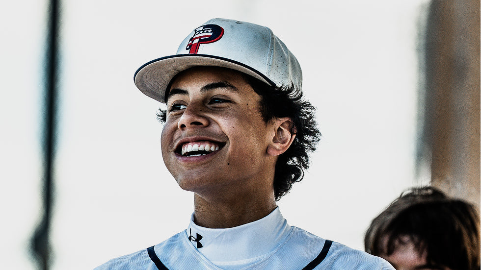 image of smiling USA Prime baseball player with USA Prime hat
